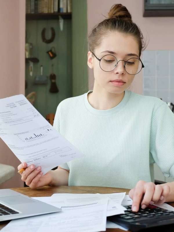 young-beautiful-woman-budgeting-managing-utilities-expenses-writing-financial-plan.jpg